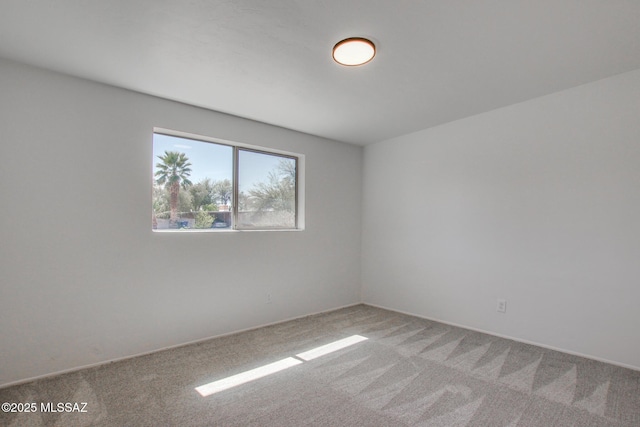 unfurnished room featuring light colored carpet