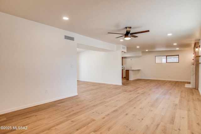 unfurnished living room featuring recessed lighting, visible vents, light wood-style floors, ceiling fan, and baseboards