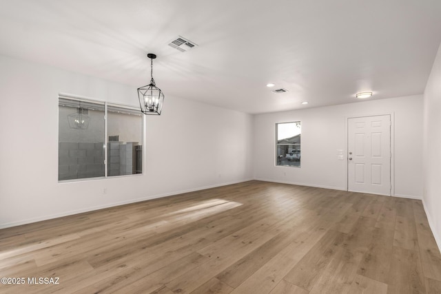 interior space featuring a chandelier and light hardwood / wood-style floors