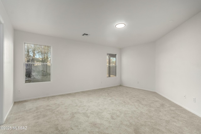 spare room with light colored carpet