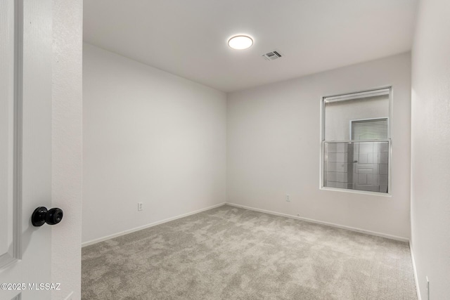 empty room featuring light colored carpet