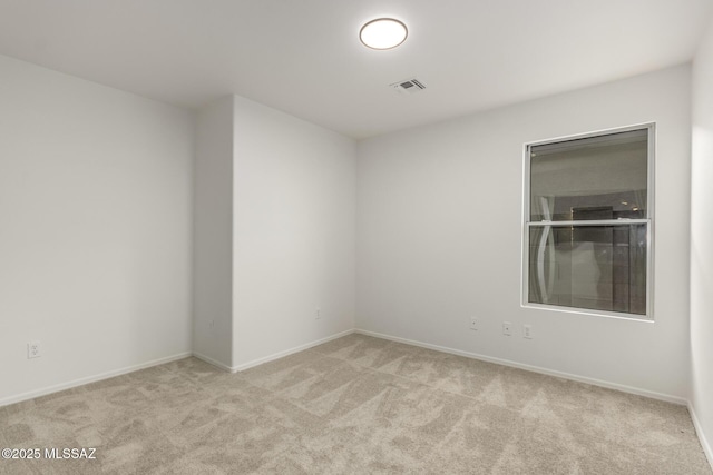 unfurnished room featuring light colored carpet