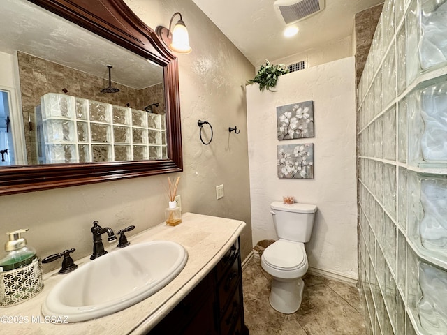 full bath with visible vents, a textured wall, toilet, tile patterned floors, and vanity