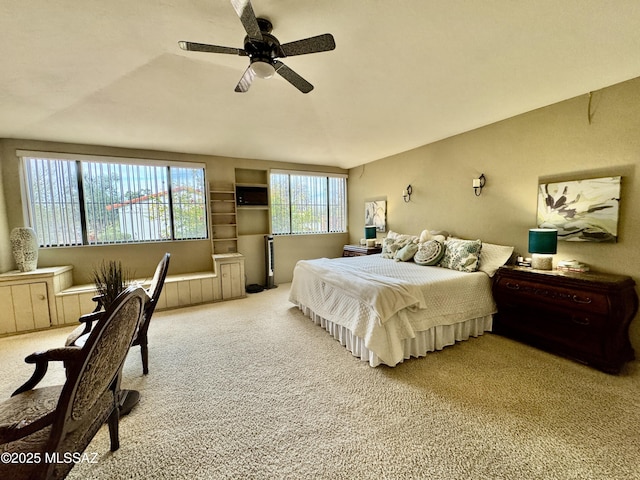 carpeted bedroom featuring vaulted ceiling and a ceiling fan