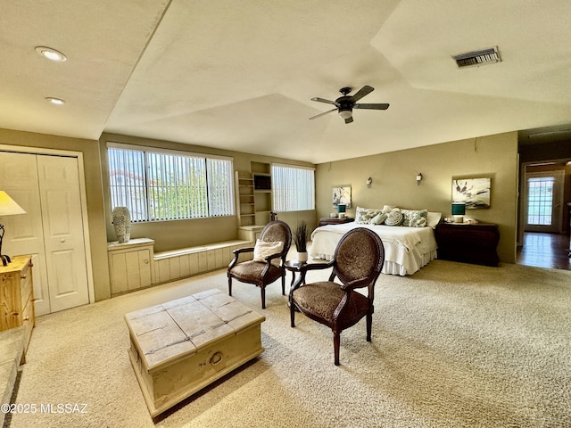 carpeted bedroom featuring lofted ceiling, ceiling fan, visible vents, and recessed lighting