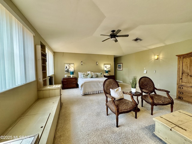 carpeted bedroom featuring vaulted ceiling, ceiling fan, and visible vents