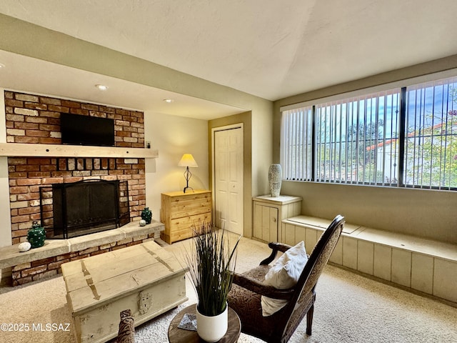 carpeted dining area with a brick fireplace