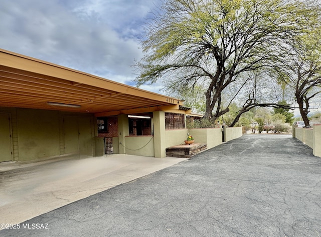 exterior space featuring fence and a carport
