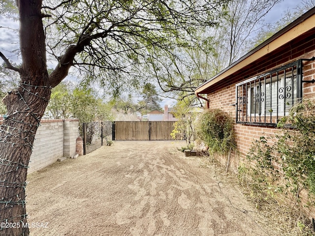 view of yard featuring a gate and fence