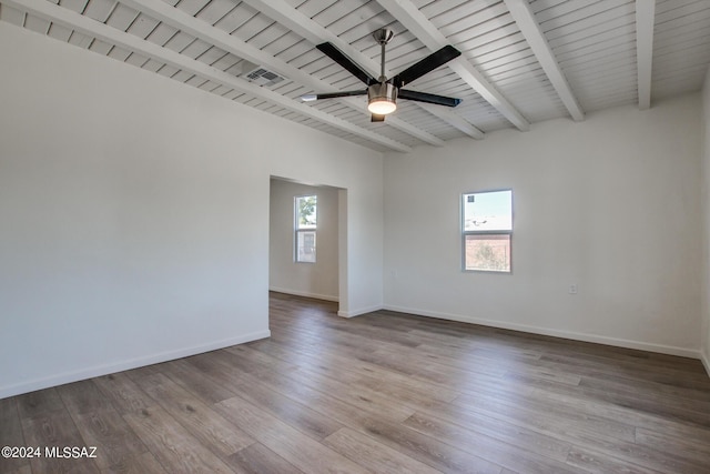 unfurnished room with ceiling fan, plenty of natural light, beam ceiling, and light wood-type flooring