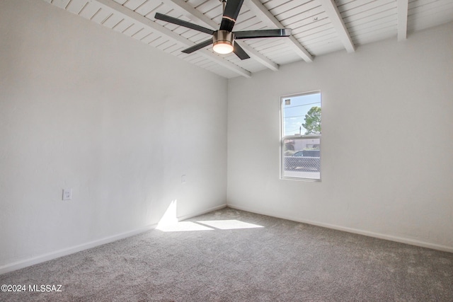 carpeted spare room with ceiling fan and beam ceiling