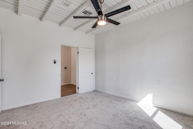 empty room with beamed ceiling, ceiling fan, wood ceiling, and light carpet