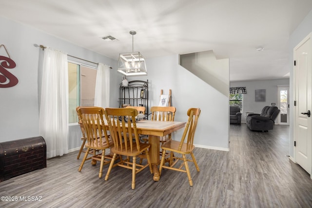 dining space with wood-type flooring