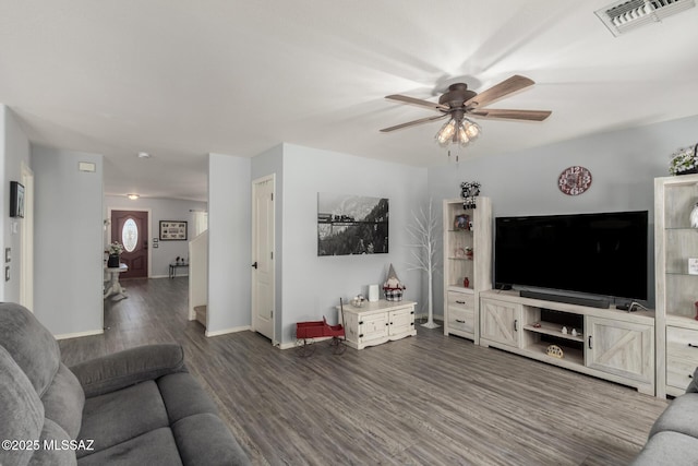 living room featuring hardwood / wood-style floors and ceiling fan