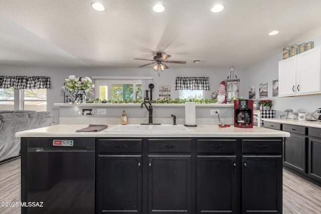 kitchen with a wealth of natural light, dishwasher, sink, and white cabinets