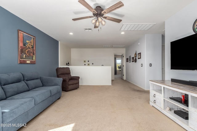 carpeted living room featuring ceiling fan