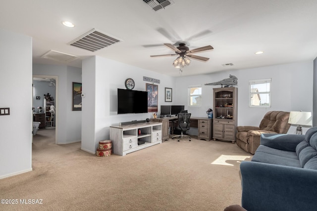 carpeted living room with ceiling fan