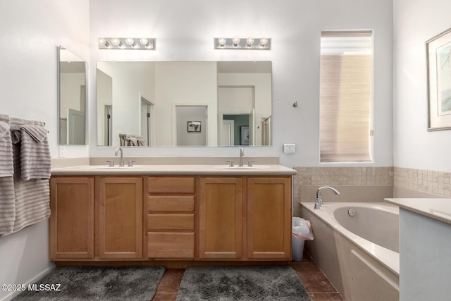 bathroom with vanity, a bath, and tile patterned floors