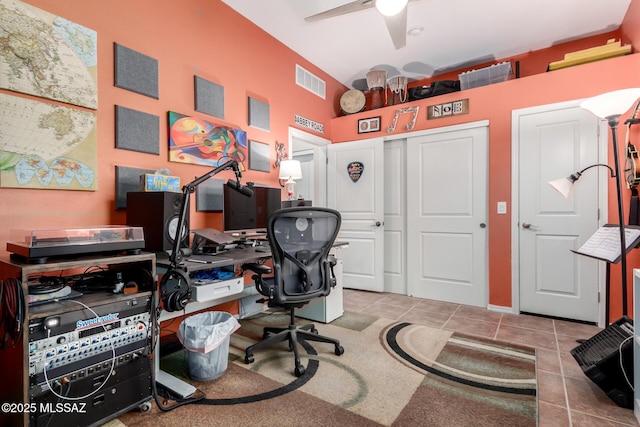 tiled office space featuring ceiling fan