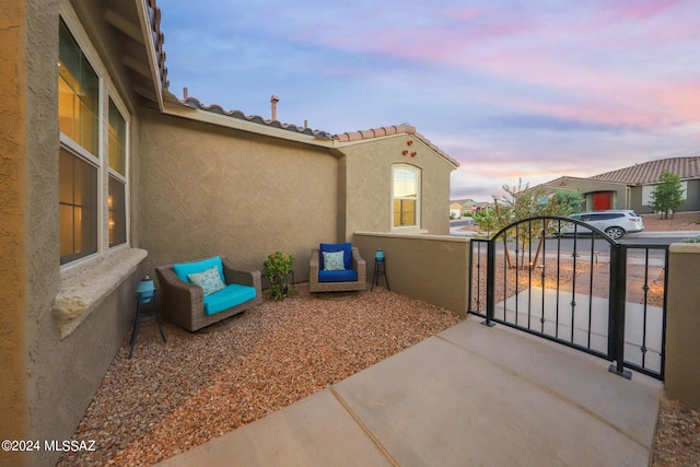 view of patio terrace at dusk