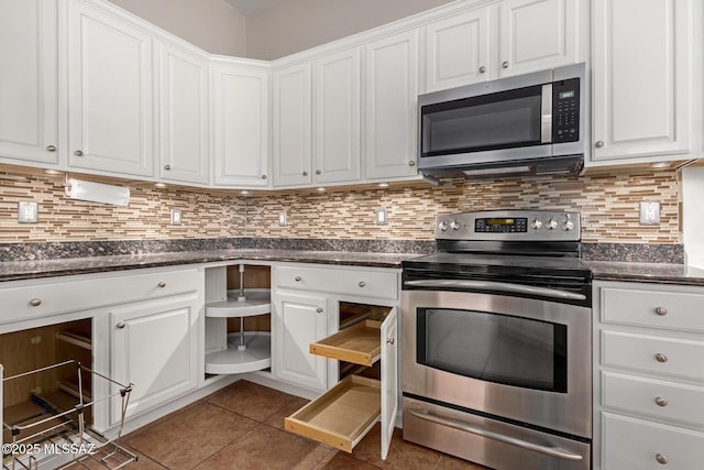 kitchen featuring backsplash, stainless steel appliances, and white cabinets