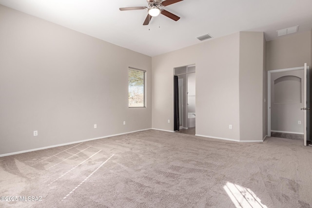 unfurnished bedroom featuring ensuite bathroom, light carpet, and ceiling fan