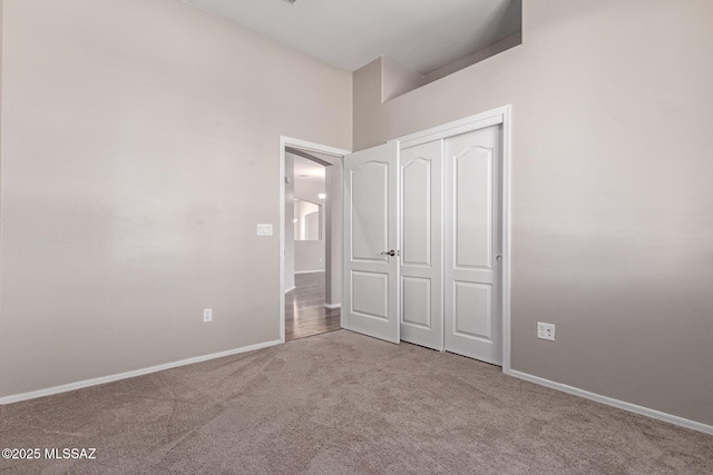 unfurnished bedroom featuring carpet floors and a closet