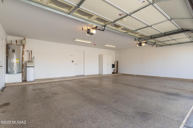 garage with water heater and a garage door opener