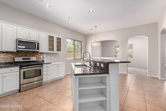 kitchen featuring sink, a center island with sink, white cabinets, and appliances with stainless steel finishes