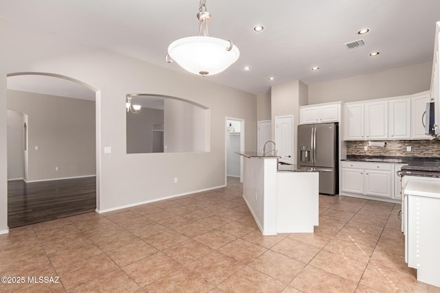 kitchen featuring pendant lighting, stainless steel appliances, backsplash, and white cabinets