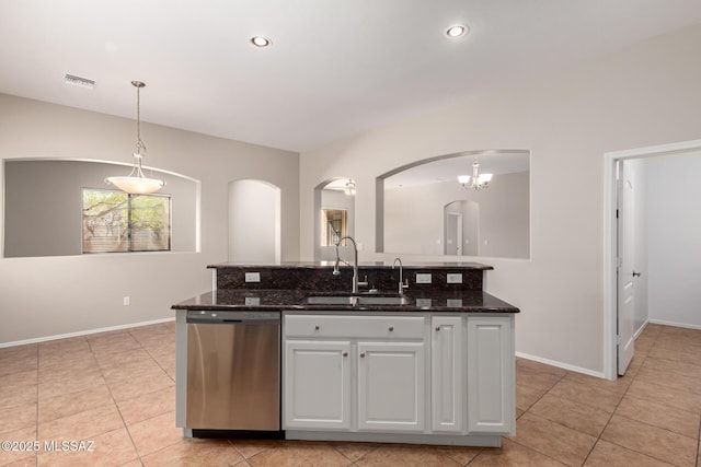 kitchen featuring decorative light fixtures, white cabinetry, sink, dark stone counters, and stainless steel dishwasher