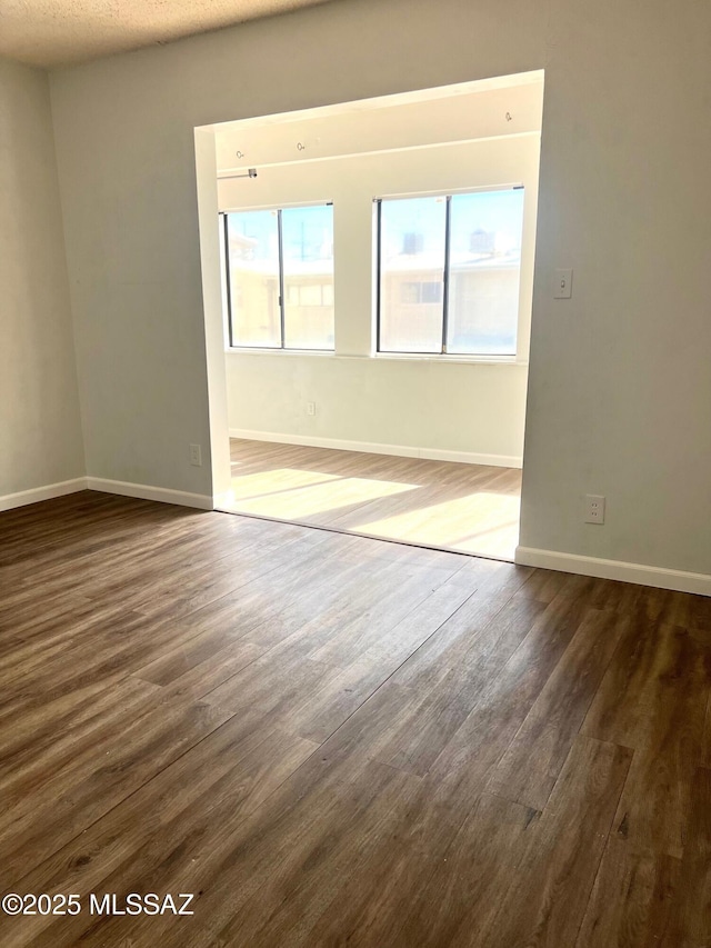 empty room with dark hardwood / wood-style floors