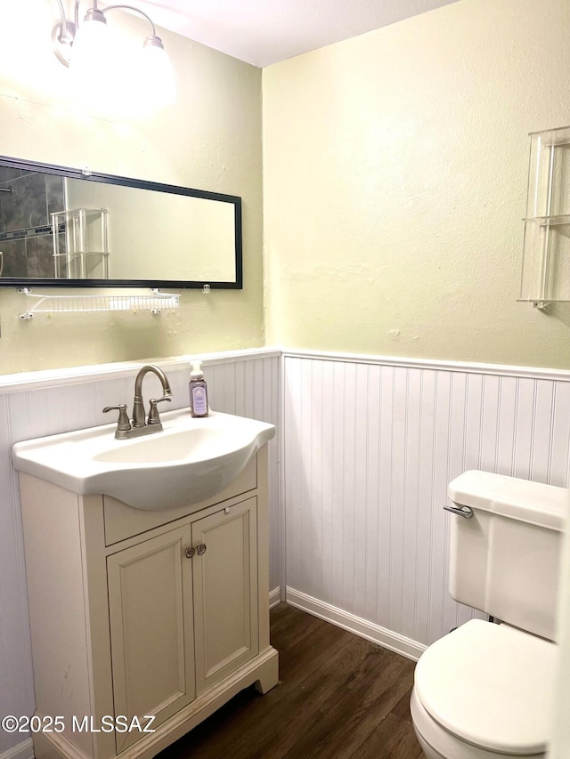 bathroom with vanity, hardwood / wood-style flooring, and toilet