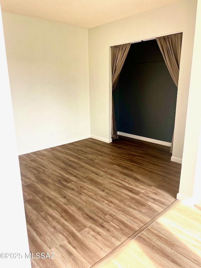 empty room with hardwood / wood-style flooring