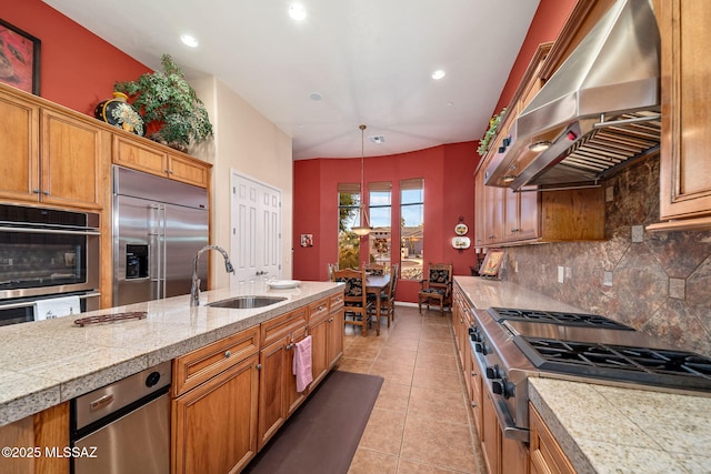 kitchen featuring tasteful backsplash, tile counters, appliances with stainless steel finishes, ventilation hood, and a sink