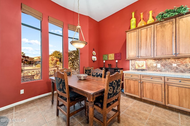 dining room featuring baseboards and light tile patterned floors