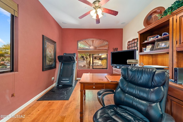 office area featuring wood-type flooring, baseboards, and a ceiling fan