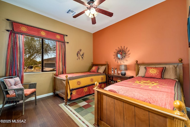 bedroom with a ceiling fan, baseboards, visible vents, and dark wood-style flooring