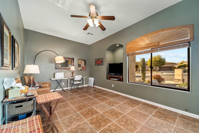 interior space featuring tile patterned flooring, visible vents, ceiling fan, and baseboards