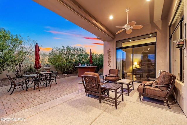 view of patio / terrace featuring ceiling fan, outdoor dining area, and an outdoor hangout area