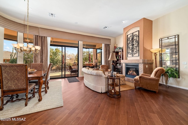 living area featuring a healthy amount of sunlight, visible vents, and a tiled fireplace