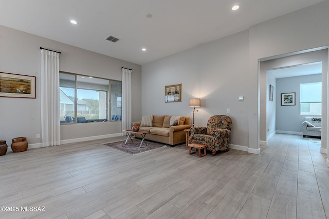 living room featuring light wood-type flooring and a wealth of natural light