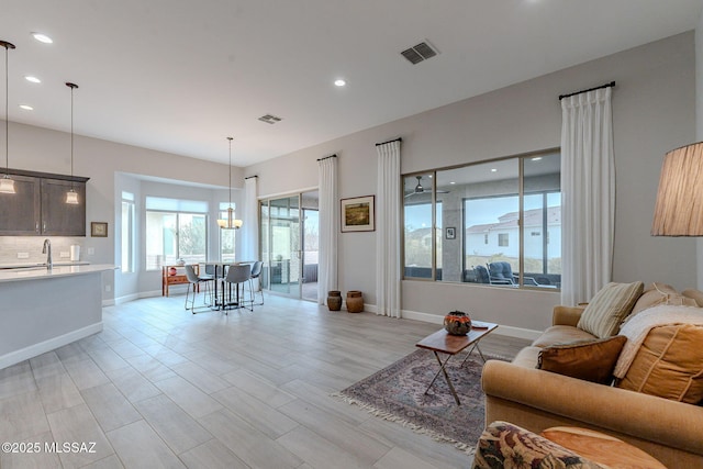 living room with sink and light wood-type flooring