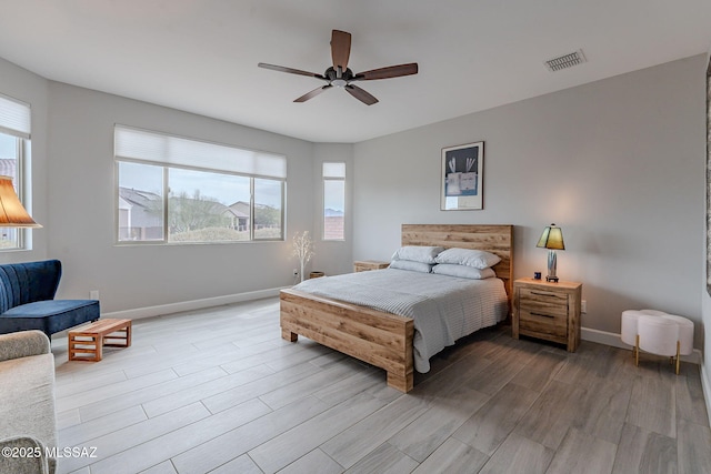 bedroom with ceiling fan and light hardwood / wood-style floors