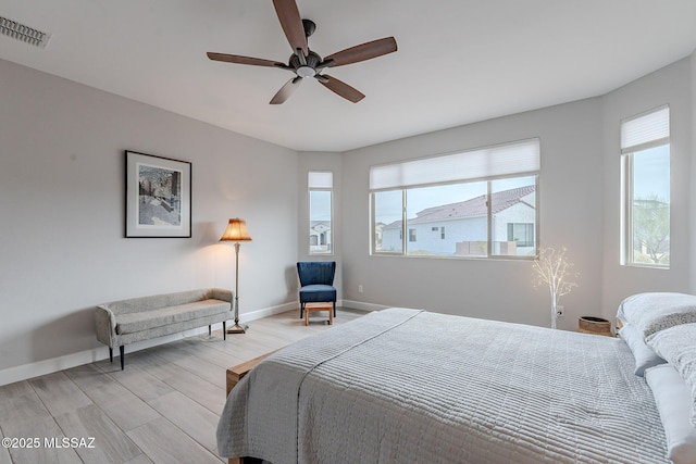 bedroom with ceiling fan and light hardwood / wood-style flooring