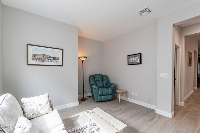 living area with light hardwood / wood-style flooring