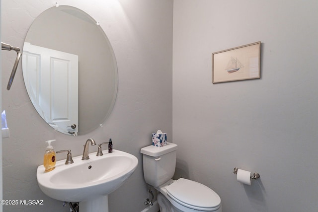 bathroom with toilet and sink