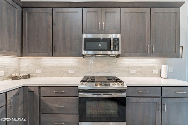 kitchen with dark brown cabinetry, stainless steel appliances, and decorative backsplash