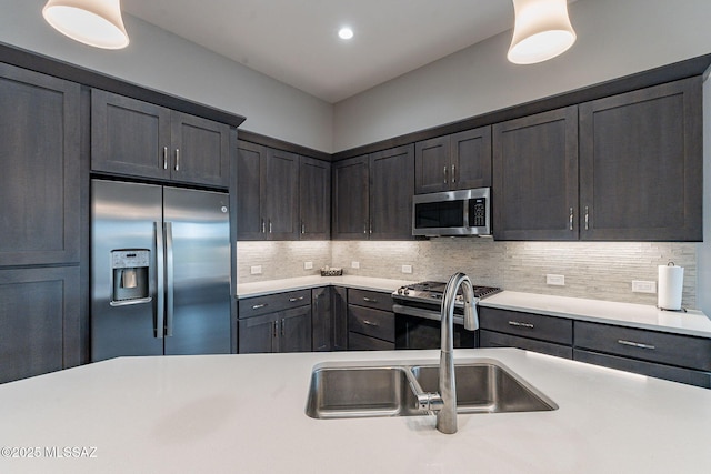 kitchen featuring stainless steel appliances, sink, and decorative backsplash