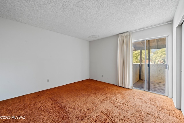 carpeted spare room with a textured ceiling